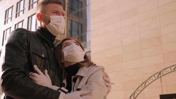 Couple in Medical Masks and Gloves in the City During a Quarantine