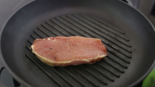 Chef Is Grilling a Steak On The Grill