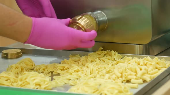 Cook Uses Machine To Make Noodles