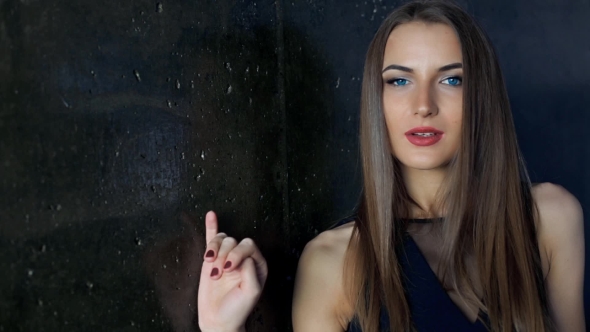 Brunette With Red Lips Posing At The Wall