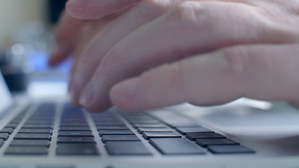 Man Typing On Laptop Computer