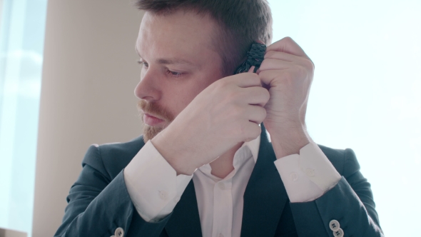 Businessman Checks And Putting On a Watch