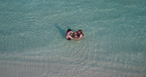 Beautiful boy and girl after marriage in love live the dream on beach on sunny white sandy