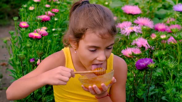 The Child Eats Honey in the Garden