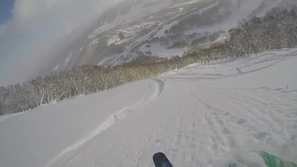 POV of a young man skier skiing on a snow covered mountain.