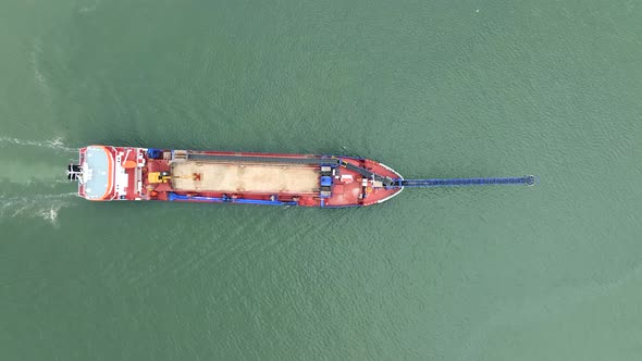 Bird's Eye View of a Self Unloading Barge Carrying Cargo At Sea