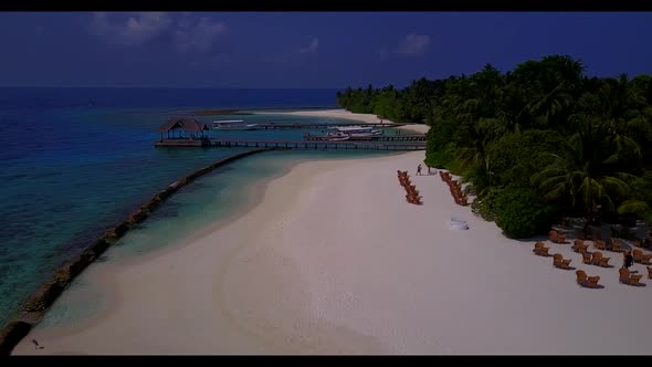 Aerial drone view panorama of exotic resort beach vacation by aqua blue lagoon and white sandy backg