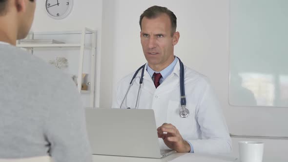 Doctor Discussing with Patient in Clinic Health Treatment