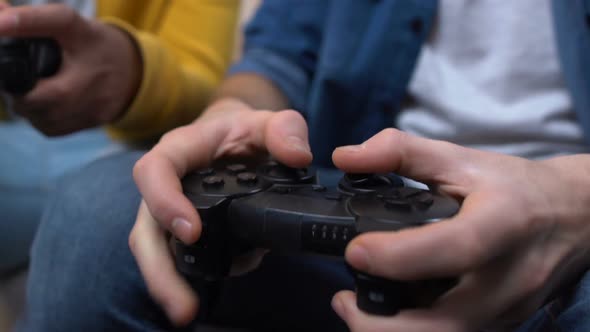 Two High School Friends Playing Video Games and Losing, Hobby, Hands Close-Up