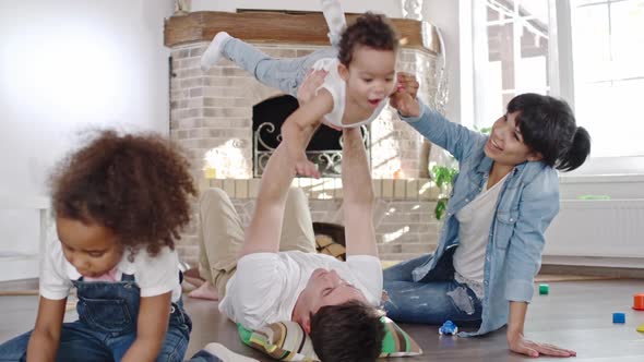 Dad lifting baby son