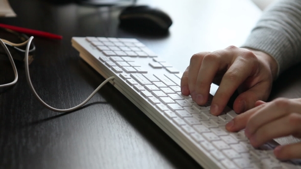 Male Hands Typing On The Keyboard