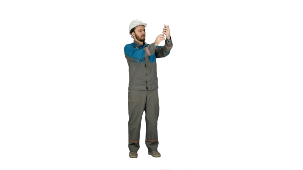 Construction Engineer In Helmet Makes Selfie On The Phone  On White Background.
