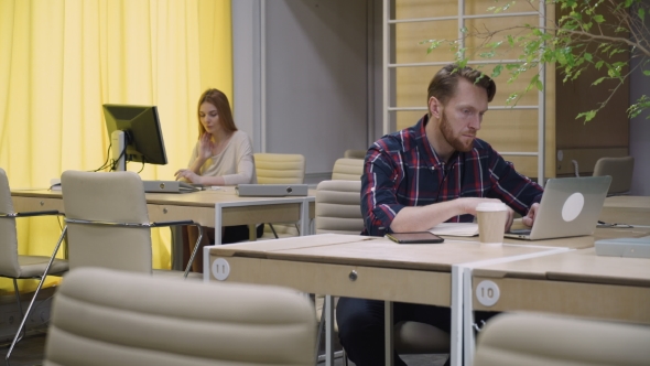 A Young Team Of Two People Working In The Office