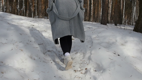 Girl Walking In Winter Forest