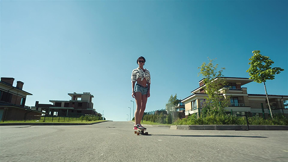 Woman Down The Road With Skateboard