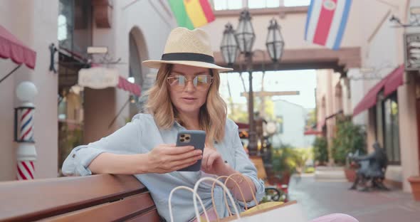 Beautiful Stylish Woman Is Checking Social Media. Pretty Model Is Reviewing Mail