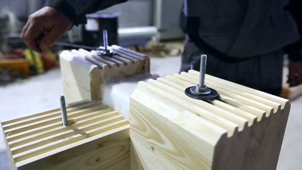 Man Tightens Fasteners With Wrench On Profiled Bar