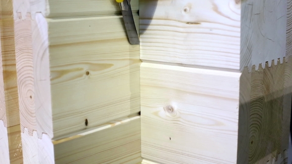 Worker Checks Profiled Glued Bars With Knife 