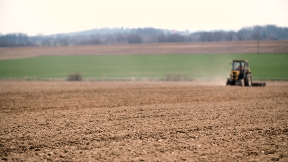 Agricultural Tractor Sowing And Cultivating Field