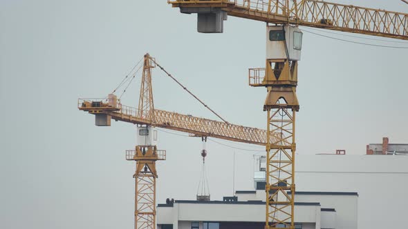 Tower Cranes at High Residential Apartment Buildings Construction Site