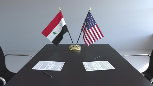 Flags of Syria and USA and Papers on the Table alt
