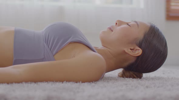 Calm of Asian woman practice yoga Dead Body or Savasana pose with meditation