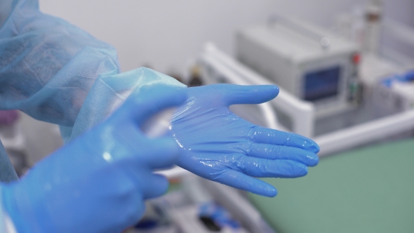 Doctor Disinfect Latex Gloves With Spray. Medicine And Health Concept