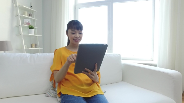 Happy Young Asian Woman With Tablet Pc At Home