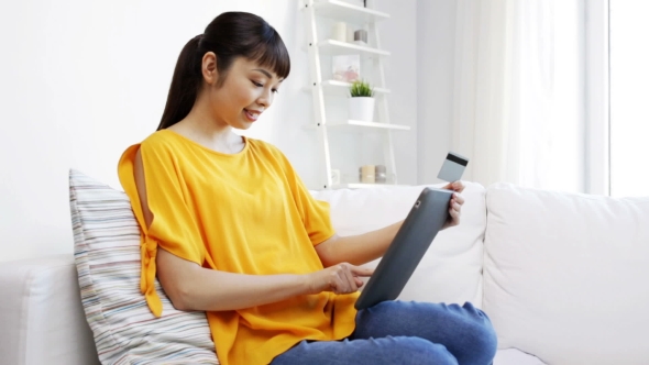 Happy Asian Woman With Tablet Pc And Credit Card