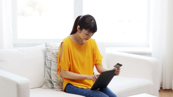 Happy Asian Woman With Tablet Pc And Credit Card