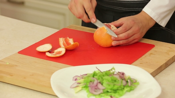 Chef Cutting Orange Fillet For Salad