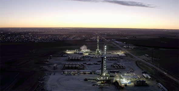 Aerial View of Illuminated Oil and Gas Drilling Platforms 