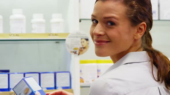 Pharmacist checking a box of medicine