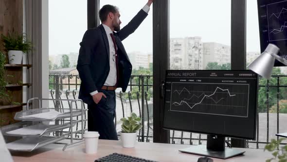 Businessman Thinking Near the Office Windows