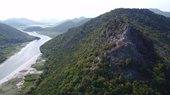 River Flowing Along the Valley Between Two Mountain Ranges