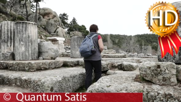 Woman Takes a Picture Among Ruins