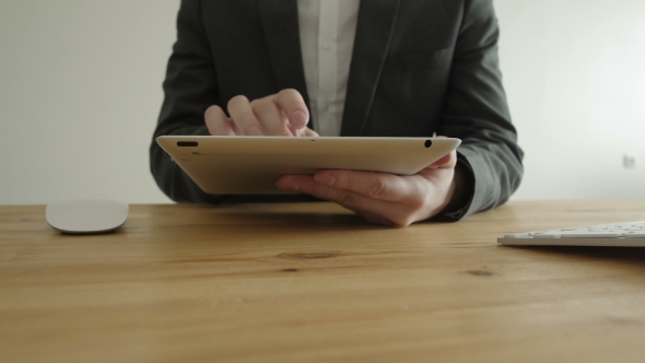  Man In a Business Suit Working With The Tablet Pad 