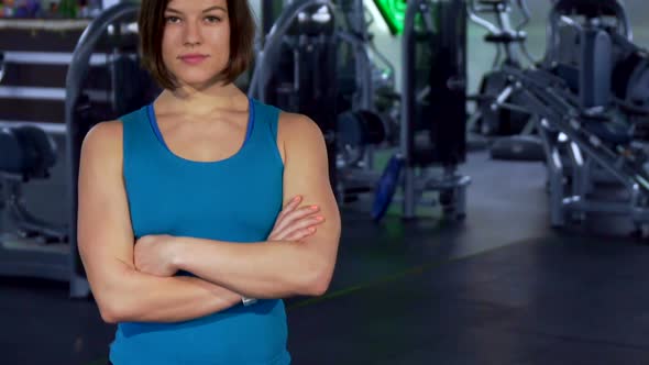 Fitness Woman Keeps Arms Crossed on Her Chest