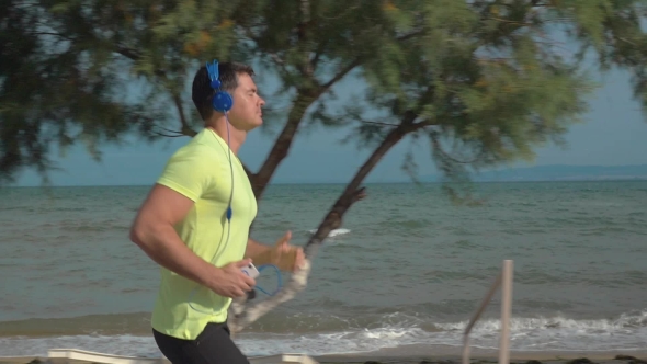 Jogging With Music And Smartphone At The Seaside