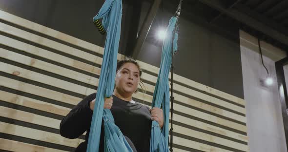 Happy Body Positive Woman Smiling and Laughing After Doing Stretching Exercise on Hammocks