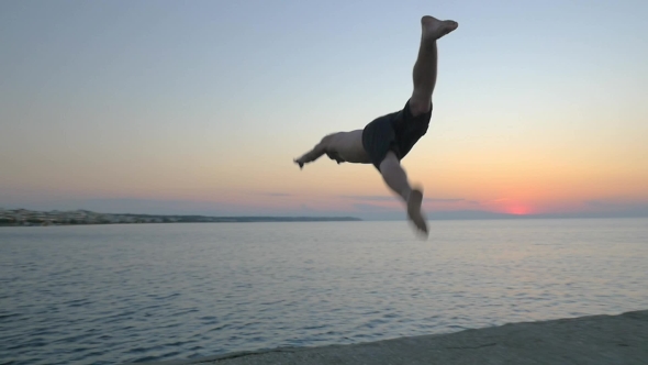 Man Doing Somersault While Jumping Into Sea