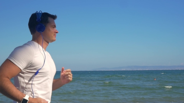 Man Jogging With Music At The Seaside