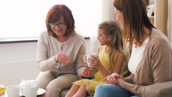 Mother, Daughter and Grandmother Having Tea Party