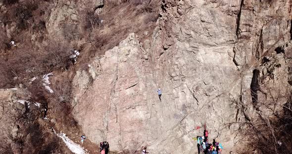 A Group of People are Engaged in Rock Climbing