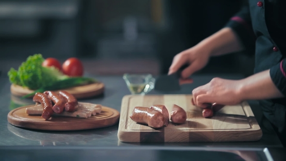 Cutting The Sausages On a Cutting Board alt