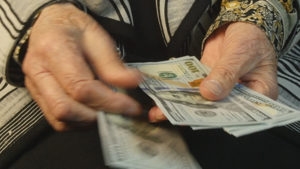 Old Woman Hands Counting Hundred Dollar Bills