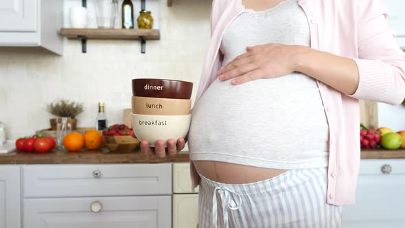 Timetable For Daily Meals During Pregnancy. Healthy Meal Plan. Pregnant Woman On Kitchen