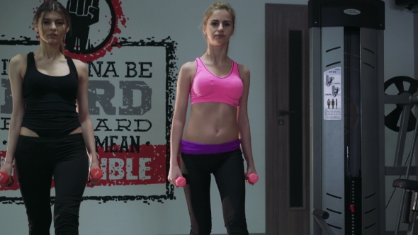 Two Beautiful Girls In The Weights At The Gym. 