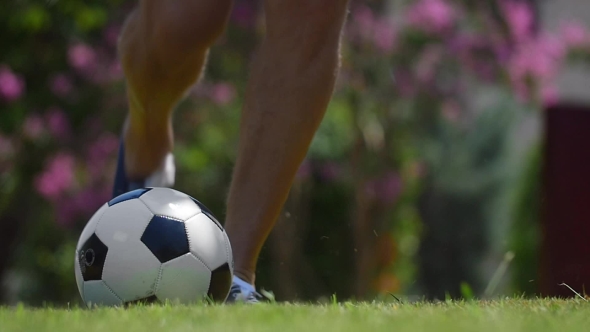 Man Kicking a Football Outdoor