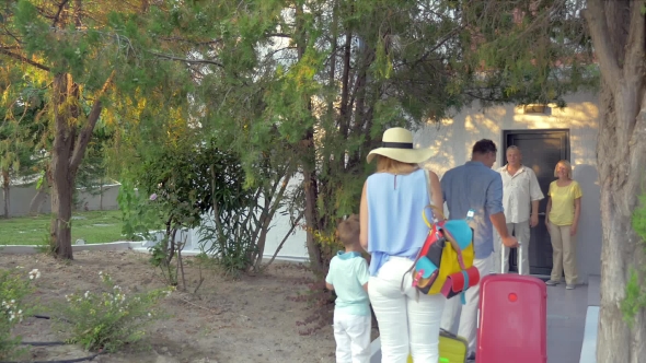 Young Family With Child Arriving To The Grandparents